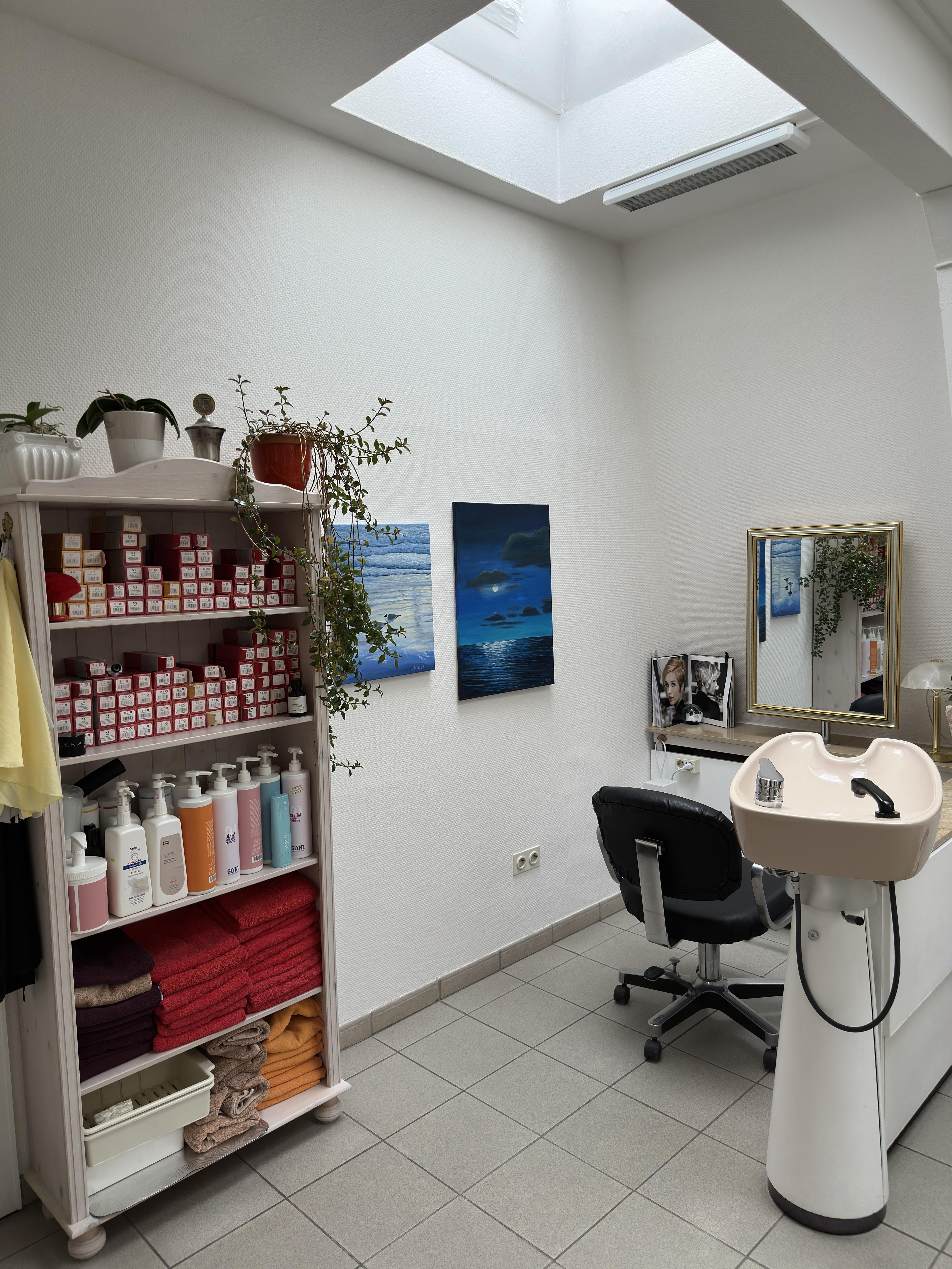 Haarpflegeprodukte und Haarwaschplatz im Friseurbereich von Apenberg Kosmetik